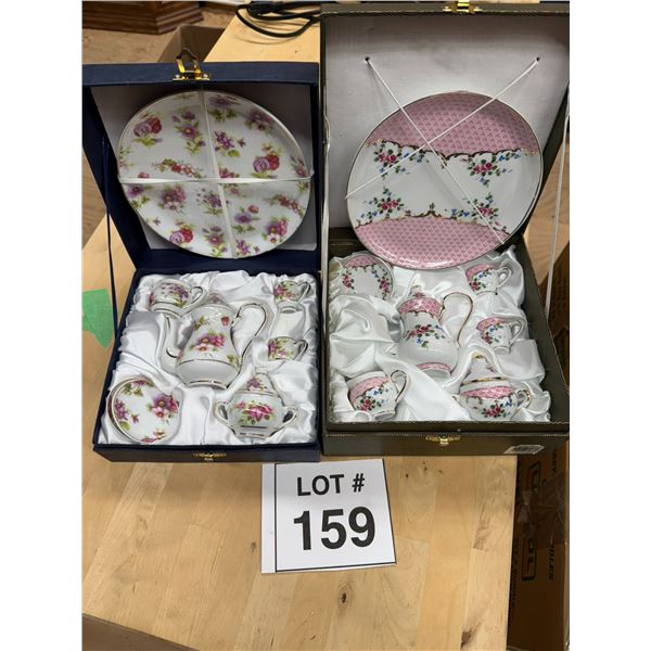TWO BOXED FLORAL PORCELAIN TEA SETS WITH SERVING PLATES